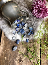 Load image into Gallery viewer, Lapis Lazuli crystals spill out of silver gauntlet onto fur, wood and framed with pretty flowers

