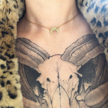 Load image into Gallery viewer, Golden crescent moon choker worn on neck with tattooed chest and leopard fur coat. 
